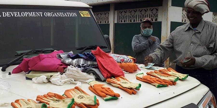 Photo of WASTE's partner, RDO Trust in India, distributing gloves and masks.