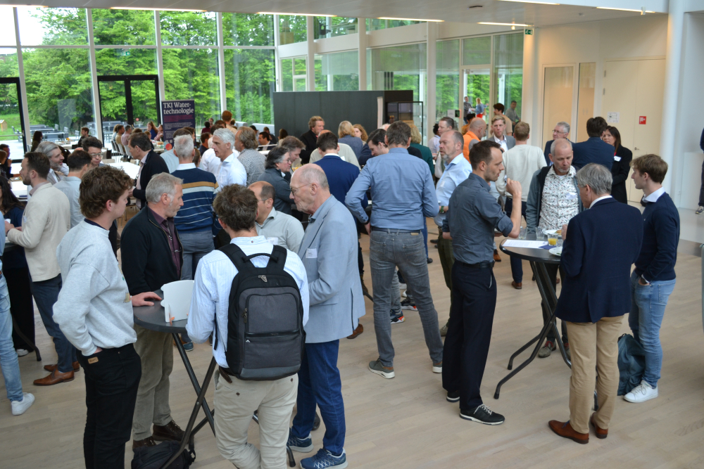 big group of people talking at tables
