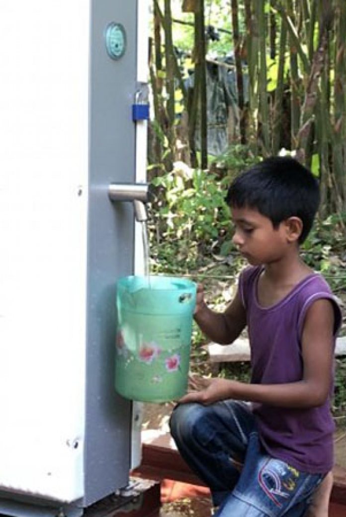 Blog-Villagepump-boy. With the push of a button, villagers can tap at least 500 litres per hour of clean water. People are instructed to use the water for drinking purposes only.