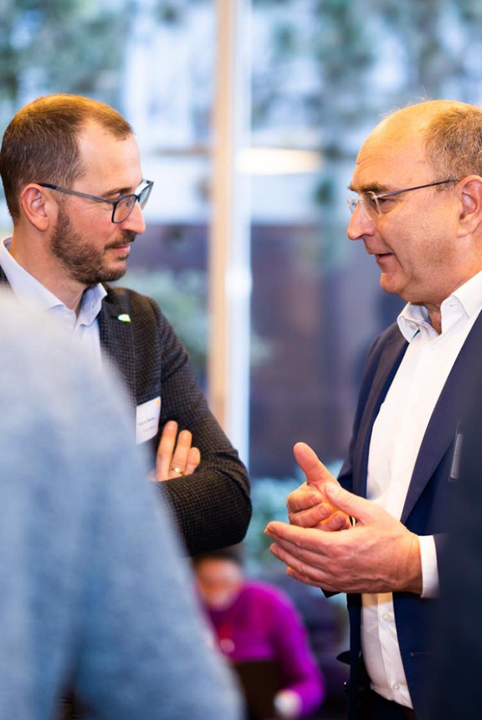 Photo of Henk Nieboer talking to a member of the NWP network.