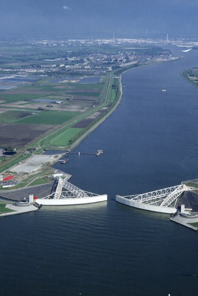Aerial vies of Nieuwe Waterweg river with Maeslant storm surge barrier almost closed