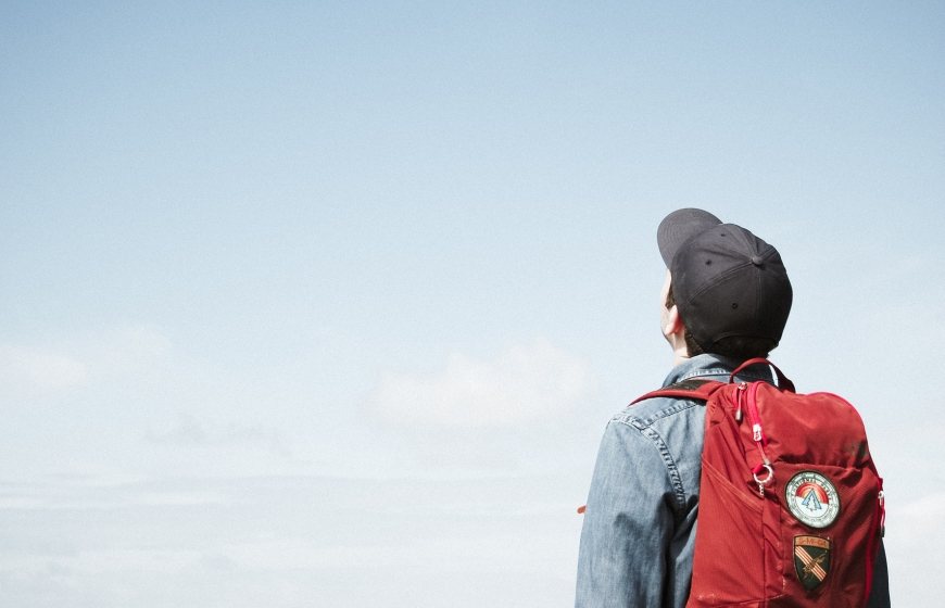 Photo of a young boy looking at the sky.