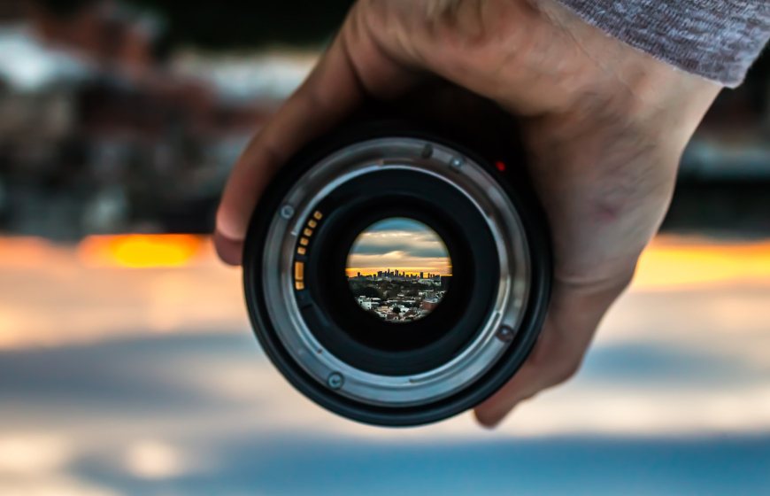 Photo of person's hand holding camera lens