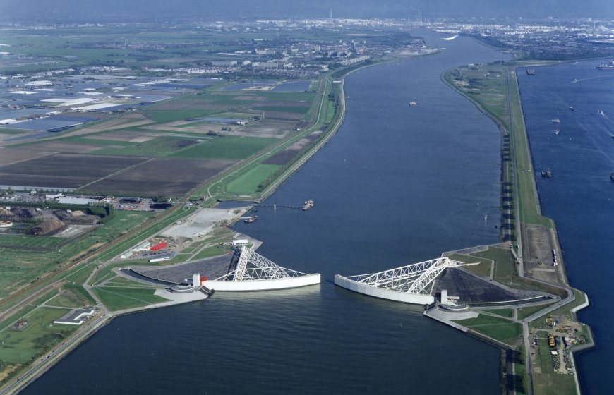 Aerial vies of Nieuwe Waterweg river with Maeslant storm surge barrier almost closed