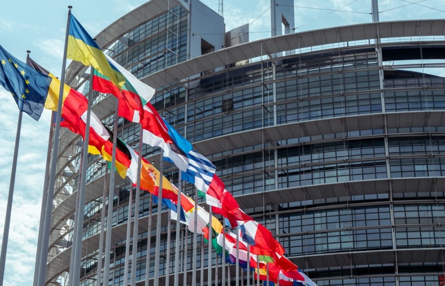 Various country flags are waving in front of the EU commission building in Brussels