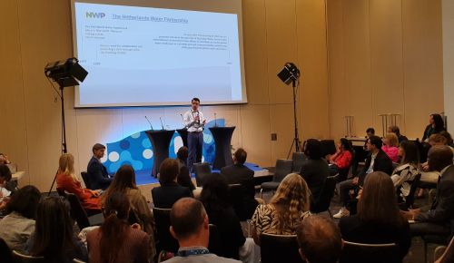 About 50 conference visitors in a conference room listen to the presentation of Rick Elmendorp of NWP at the NoWNET meeting at Stockholm World Water Week 2024