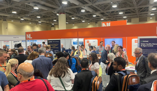 Many congress attendees gather at the orange coloured Netherlands Lounge on the exhibition floor of the congress in Toronto, Canada