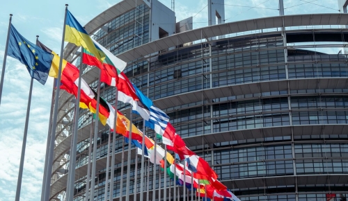 Various country flags are waving in front of the EU commission building in Brussels